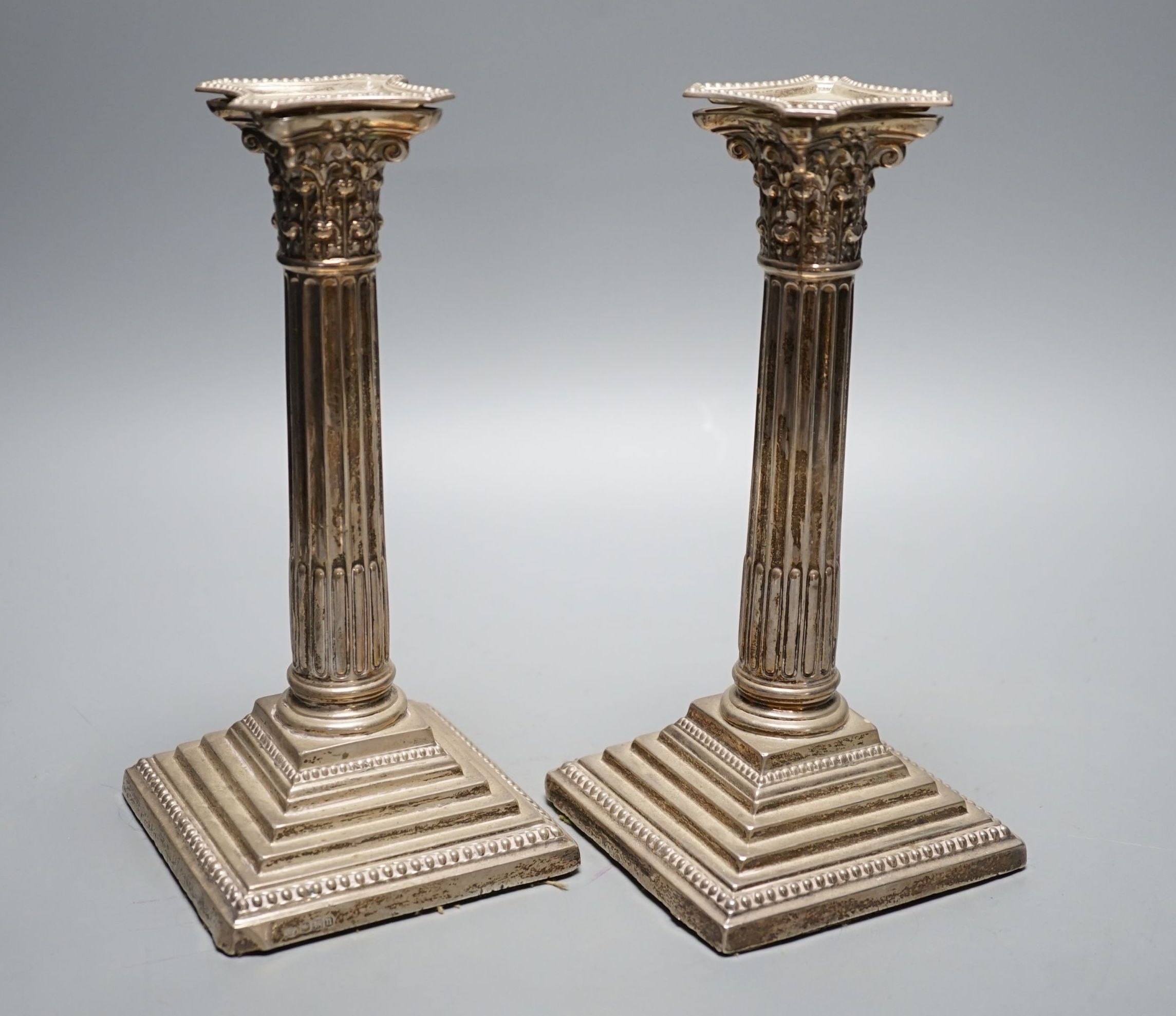 A pair of George V silver Corinthian column candlesticks, Robert Pringle & Sons, Sheffield, 1930, height 21.6cm, weighted.